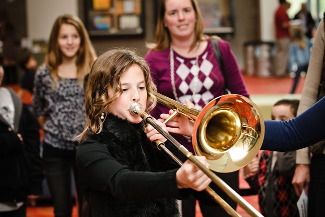 Trying out the trombone during an Instrument Petting Zoo at Symphony Hall. Photo courtesy of The Phoenix Symphony.