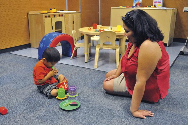 Veronica Castillo of Phoenix and her grandson, Lorenzo Castillo (4), visited the eating assessment playroom at an open house for the Children’s Developmental Center. Photo by Daniel Friedman.