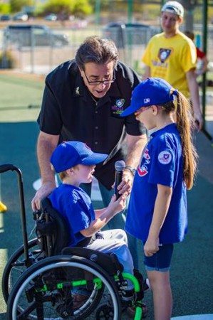 Zach Zurliene and Alyssa Duhame lead the crowd in a rousing rendition of “Take me Out to the Ballgame” on opening day for the Miracle League of Arizona's spring season.