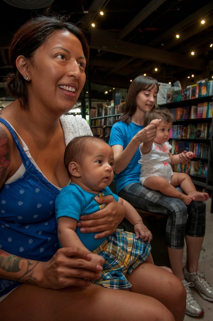 Katie Morin with her son, 2-month-old Max, listen during BabyTime at Changing Hands in Phoenix.