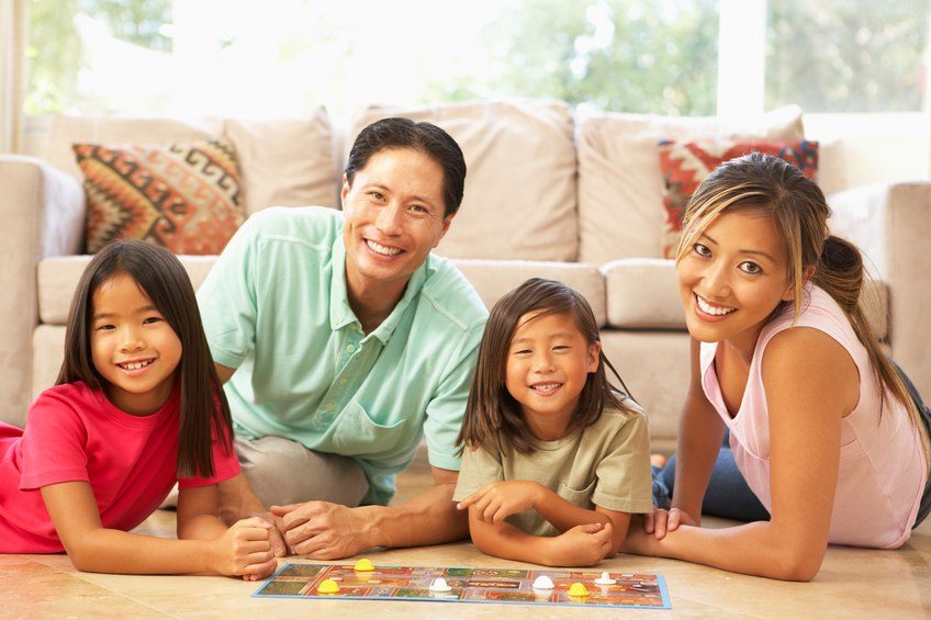 Family Playing Board Game At Home