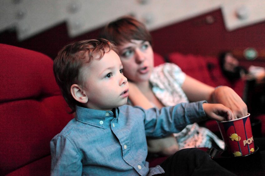 The family eating popcorn in the cinema