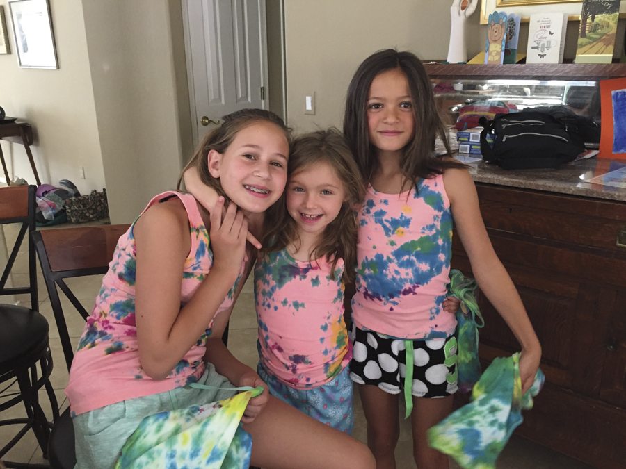 Martha Christiansen’s grandchildren (from left) Madison Mobley (12), of Golden, Colorado, Cate Mobley (6), of Phoenix, and Sadie Mobley (9), of Golden, wear the tie-dye T-shirts they made at “Camp Nana and Poppy.” Photo courtesy of Martha Christiansen.