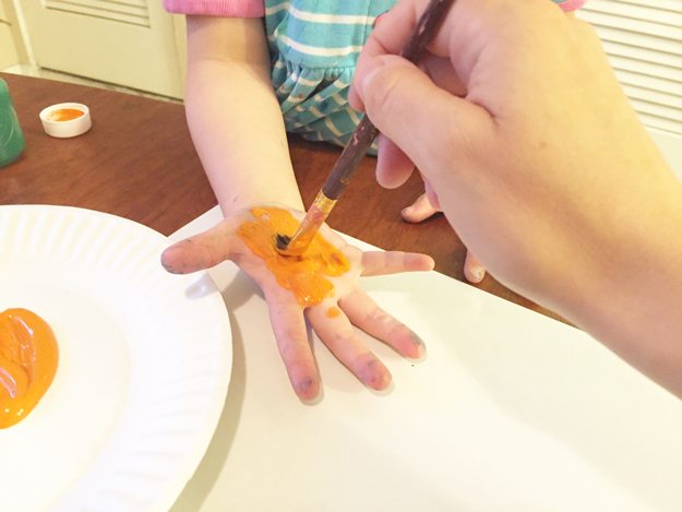 undersea-step4, paper plate, orange paint, hand, paintbrush
