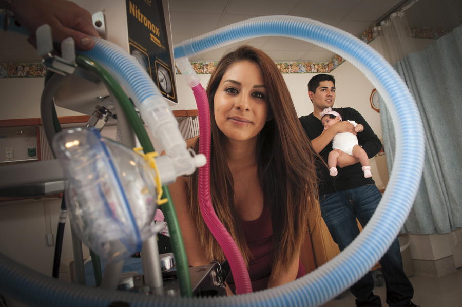 Amanda Williamson with husband P.J. Cerano and their daughter Sophia in a birthing suite at Tempe St. Luke’s Hospital. Williamson chose to use nitrous oxide rather than an epidural when she gave birth to Sophia, her second child, in August. Photo by Rick D'Elia.