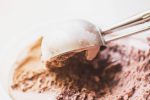 Chocolate ice cream scoop, scooped out of a container with a utensil