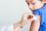 Young boy receives vaccine injection