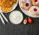 Symbols of Hanukkah celebration on wood background