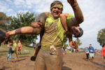 Male runner carrying a female participant near the finish line